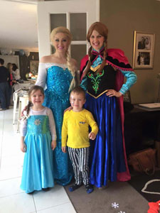 Queen Elsa and Princess Anna at child's birthday party 